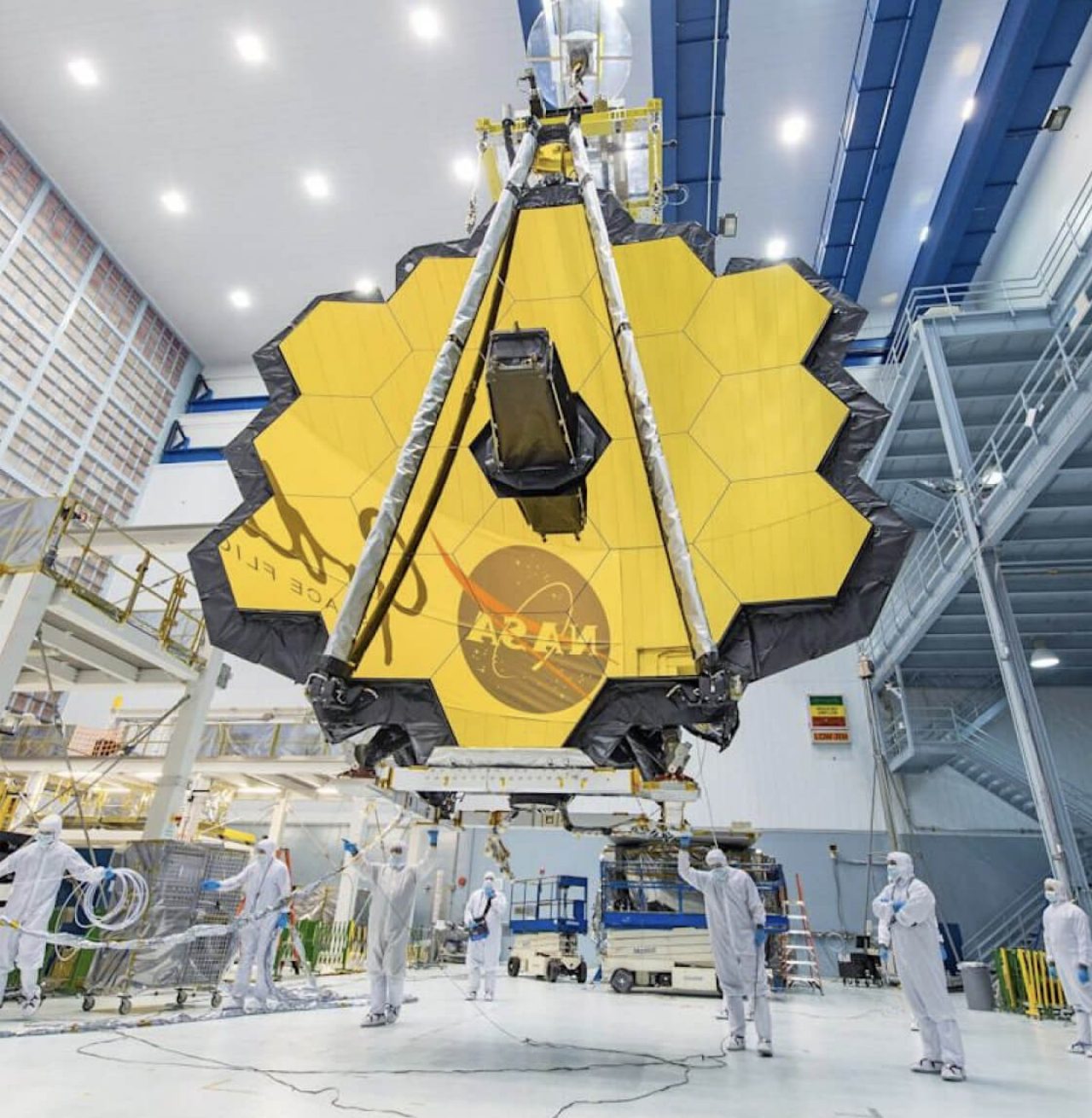 NASA technicians lifting the telescope and moving it into the clean room at NASA’s Goddard Space Flight Center in Greenbelt, MD